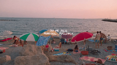 a beach filled with lots of people and umbrellas