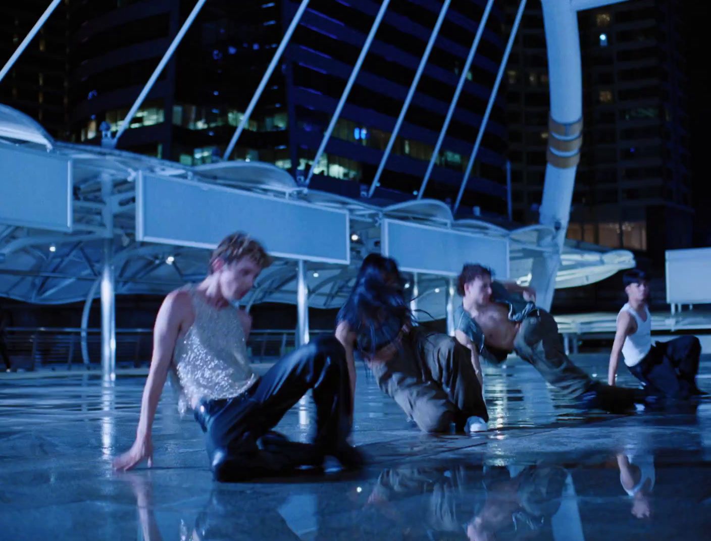 a group of people sitting on the ground in front of a building