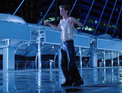 a man standing in front of a white piano