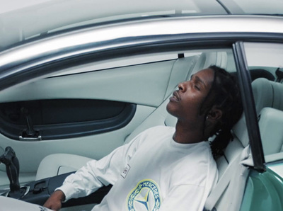 a woman sitting in a car with her head out the window