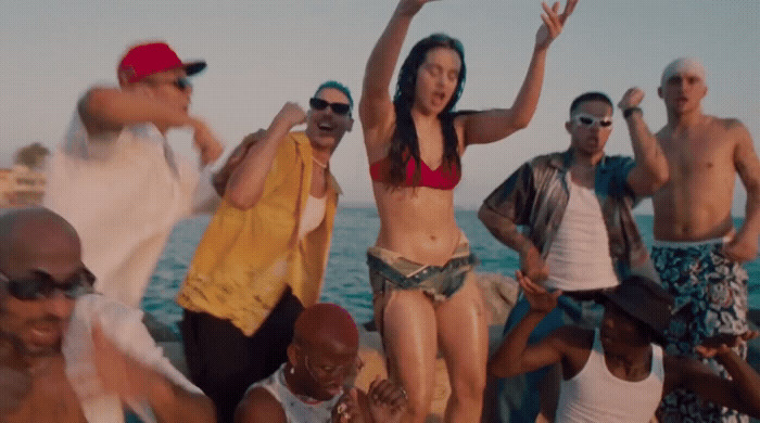 a group of people standing next to each other on a beach