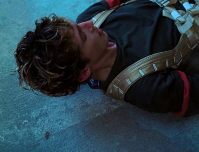 a man laying on the ground with a backpack on his back