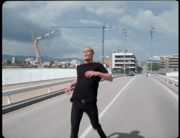 a man riding a skateboard across a bridge