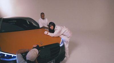 a man and a woman standing next to a car