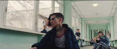 a group of people in a room with green walls