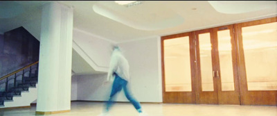 a blurry photo of a person walking in a room