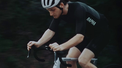 a man riding a bike with a helmet on