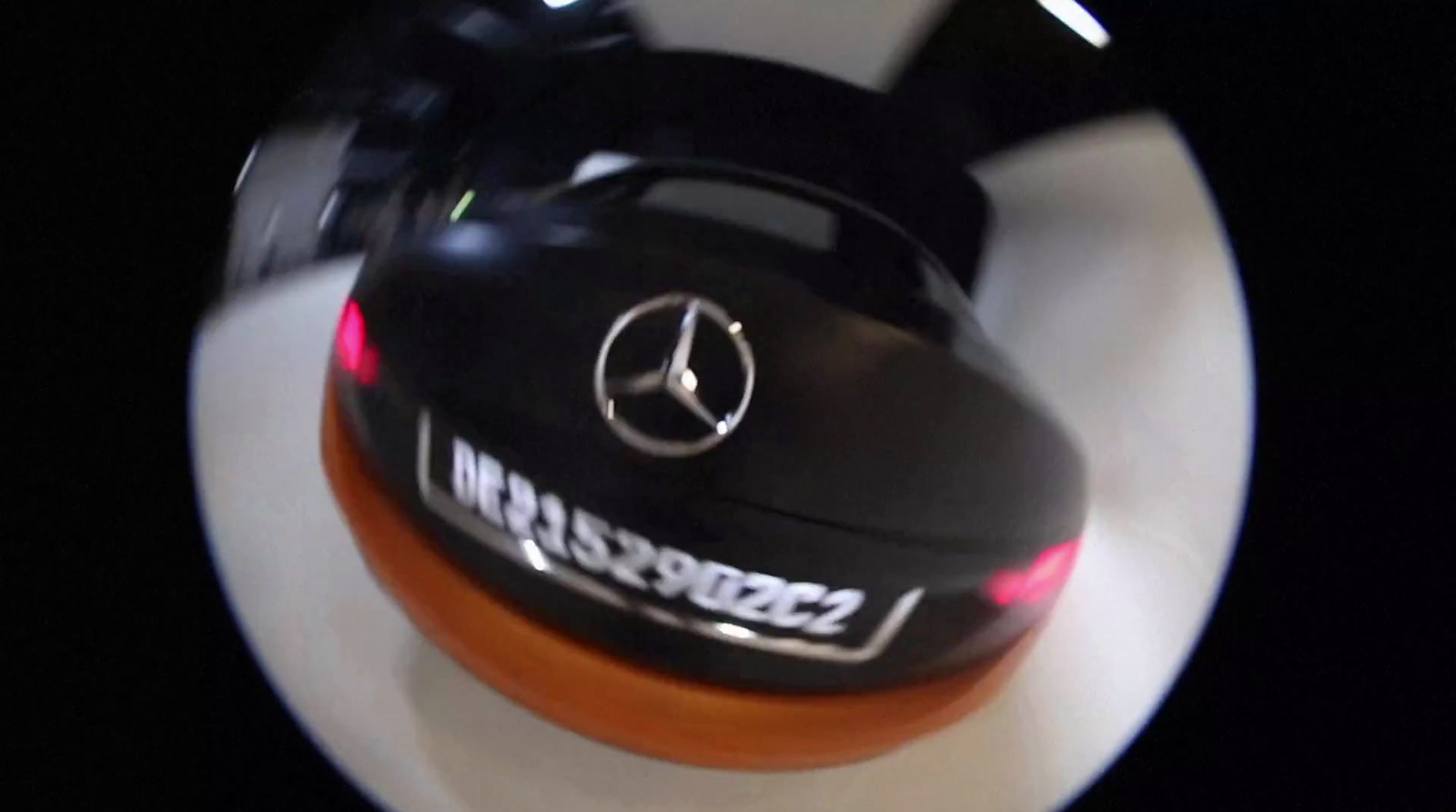 a close up of a cake with a mercedes logo on it