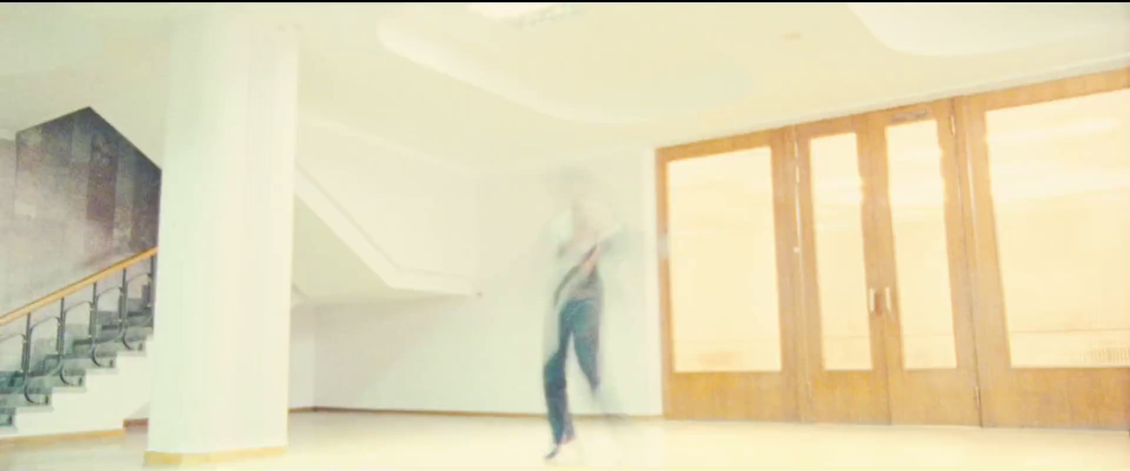 a blurry photo of a person walking down a hallway