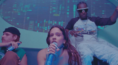 a group of people sitting on top of a blue couch