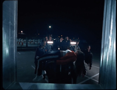 a group of people standing around in a parking lot