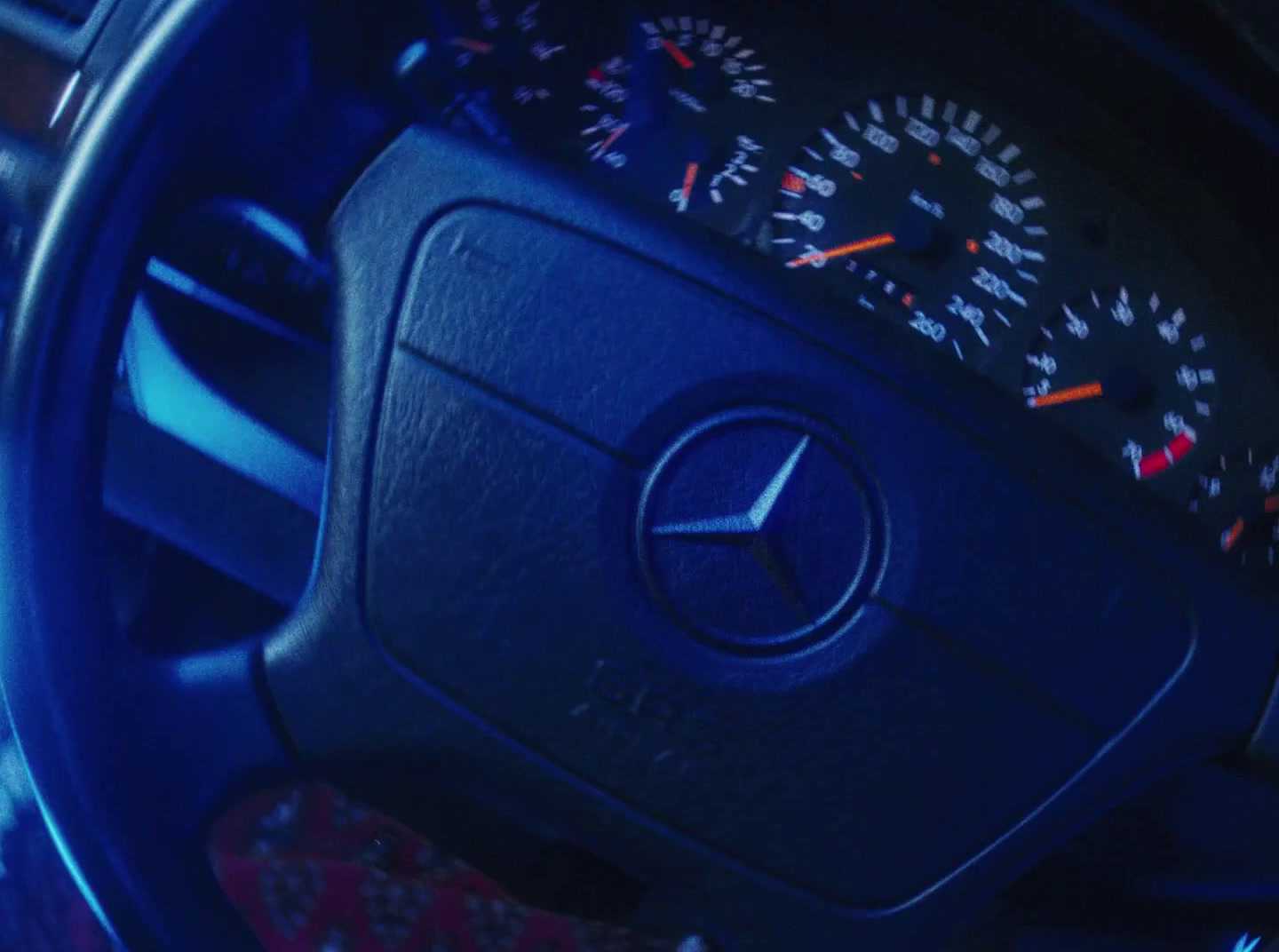 a close up of a steering wheel with a speedometer