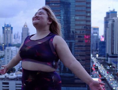 a woman standing in front of a city skyline