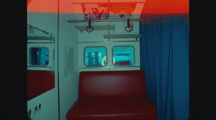 a train car with a red seat and a blue curtain