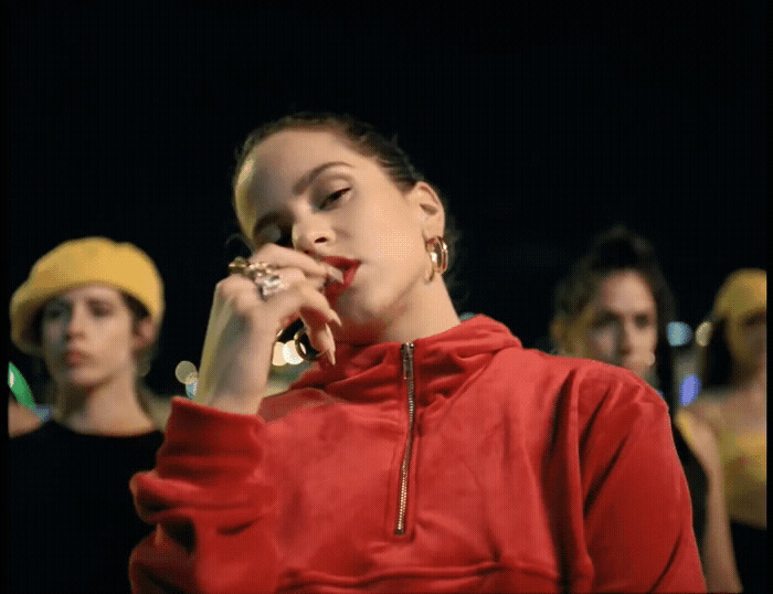 a woman in a red jacket talking on a cell phone