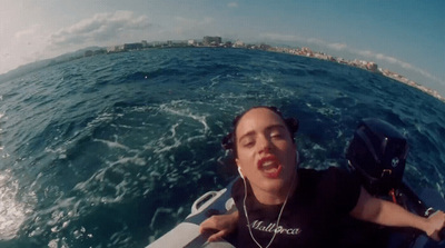 a woman riding a boat on top of a body of water