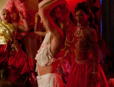 a group of women in costume dancing on stage