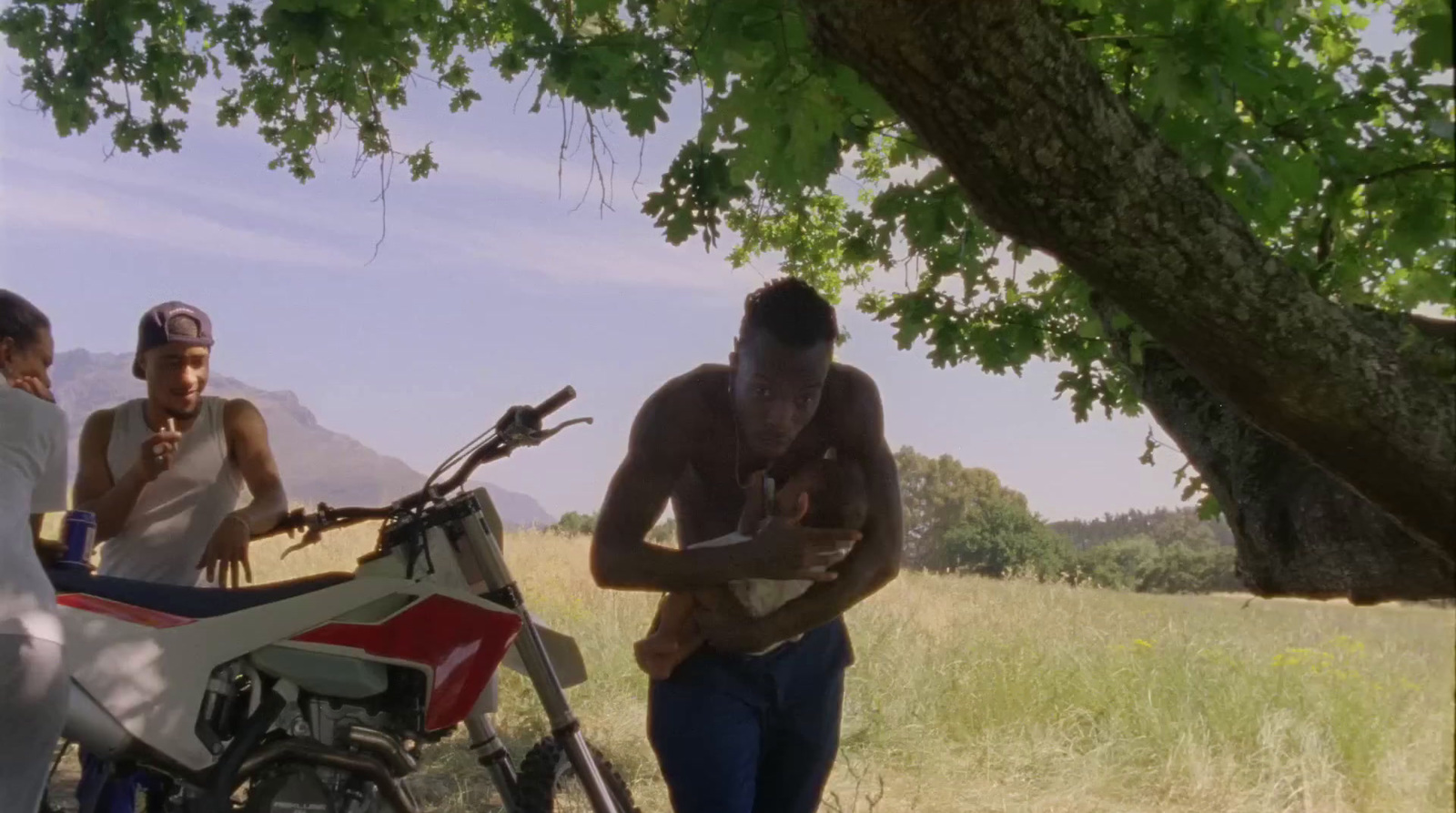 a group of people standing around a motorcycle