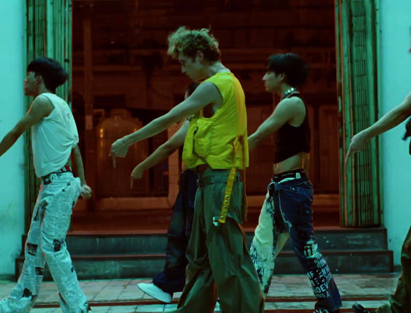 a group of young men and women walking down a street