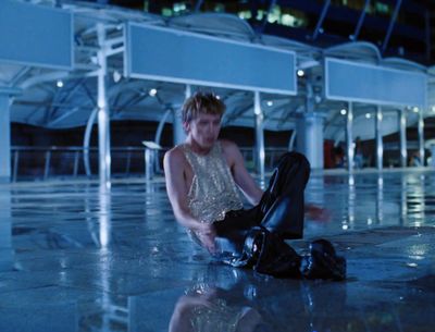 a man sitting on the ground with a suit case