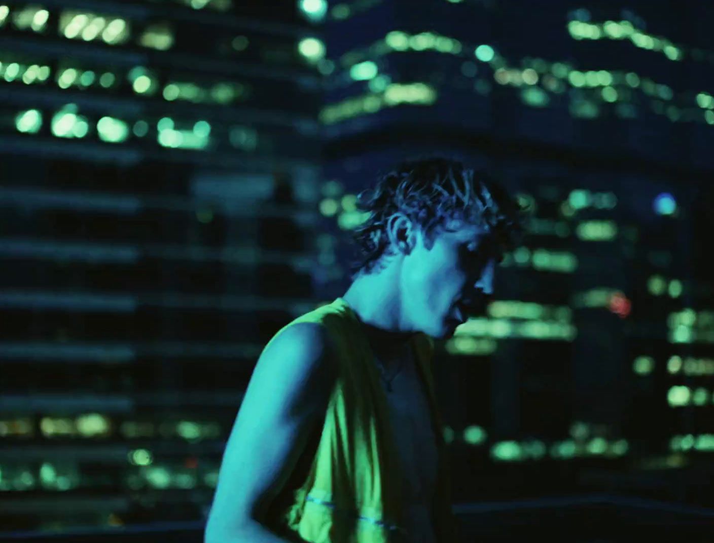 a man standing in front of a city at night