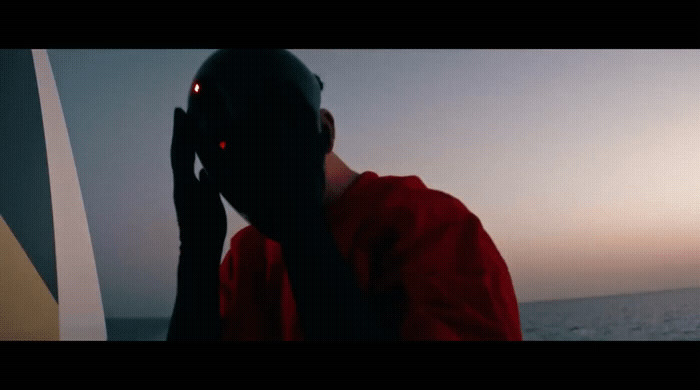 a man in a red jacket talking on a cell phone