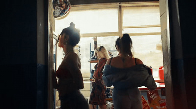 a group of women standing in front of a window