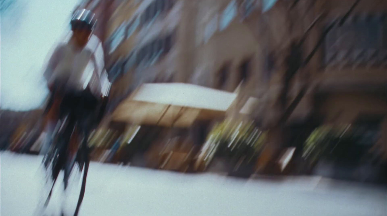 a man riding a bike down a snow covered street