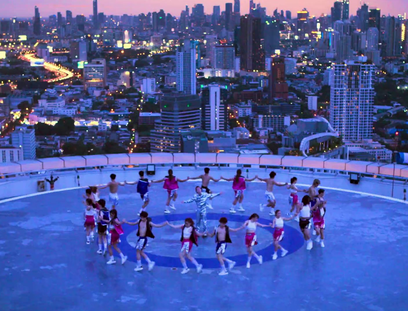 a group of people standing on top of a building