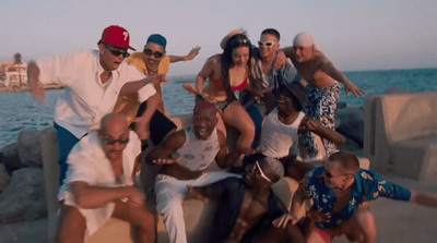 a group of people posing for a picture by the water