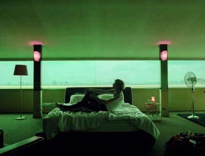 a man laying on a bed in a room