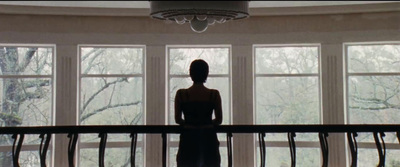 a woman standing in front of a large window