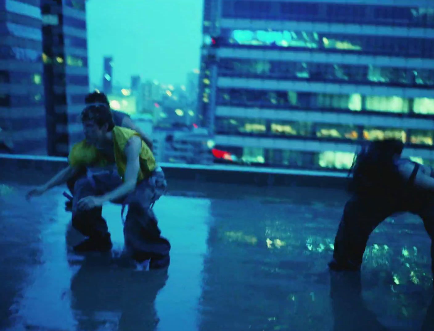 a couple of people standing on top of a roof