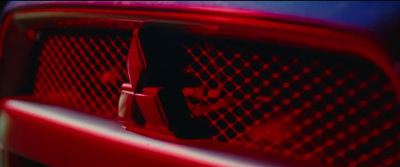 a close up of a red grille on a car