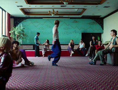 a group of people sitting and standing in a room