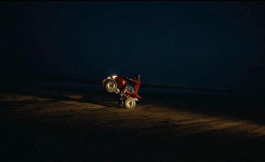 a tractor in the dark on a dirt road