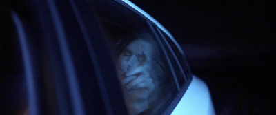 a person's face is seen through the window of a car