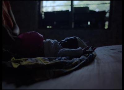 a person laying on a bed in a dark room