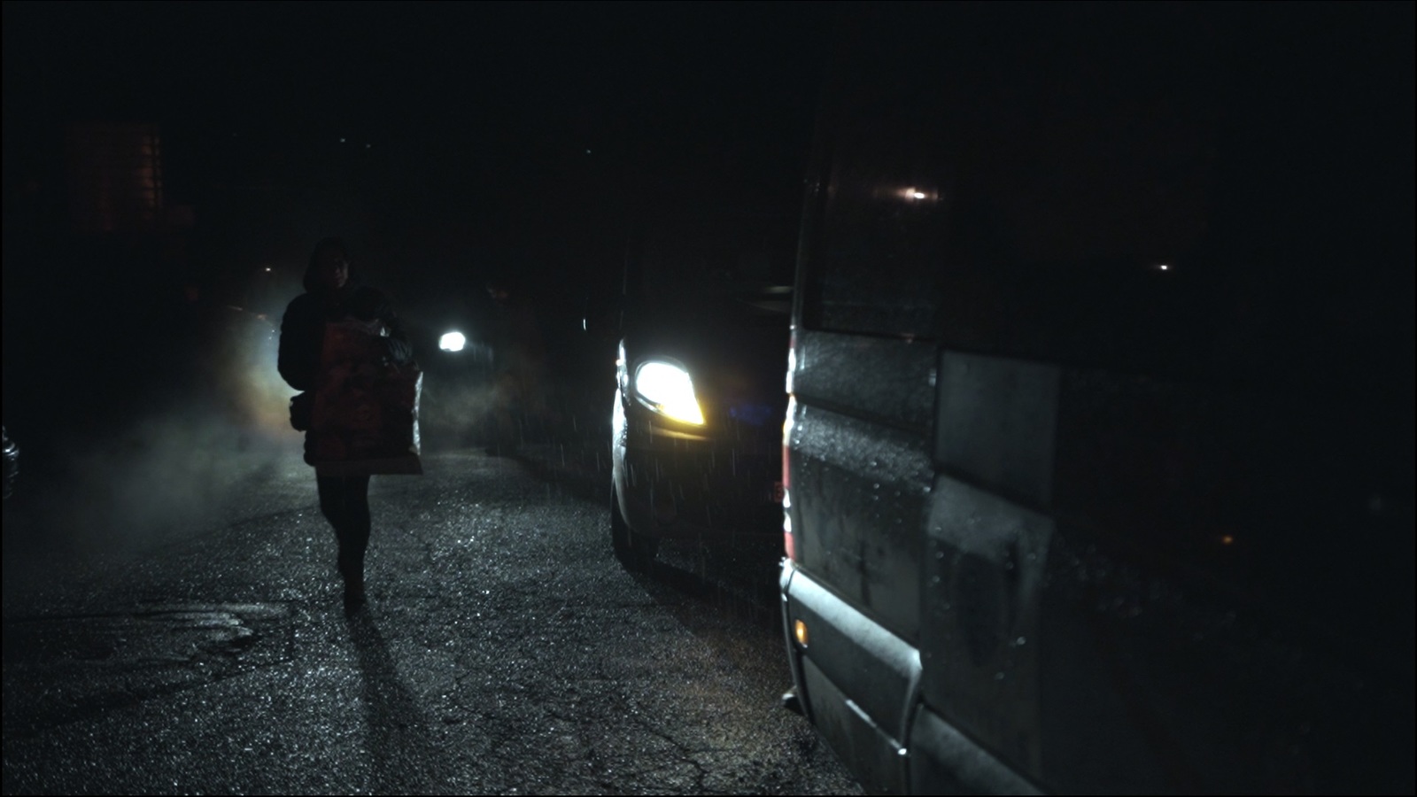 a person walking down a dark street at night