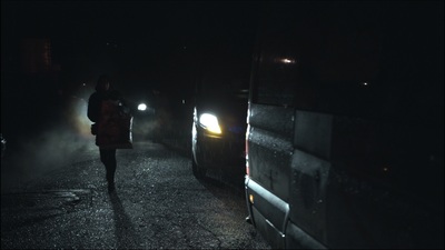 a person walking down a dark street at night