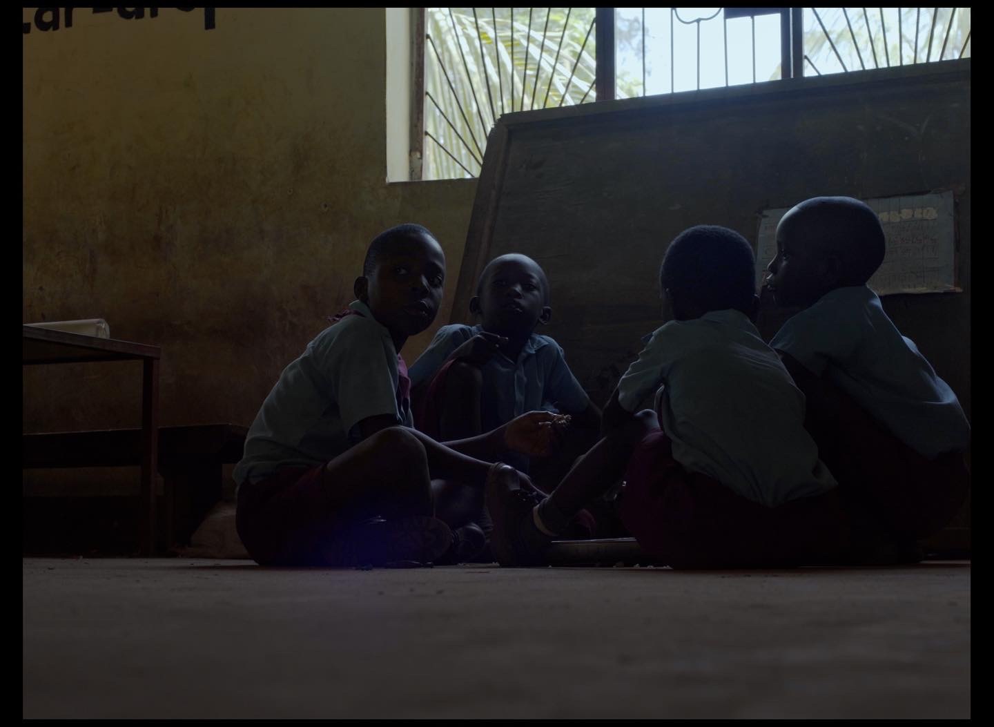 a group of people sitting on the floor in a room