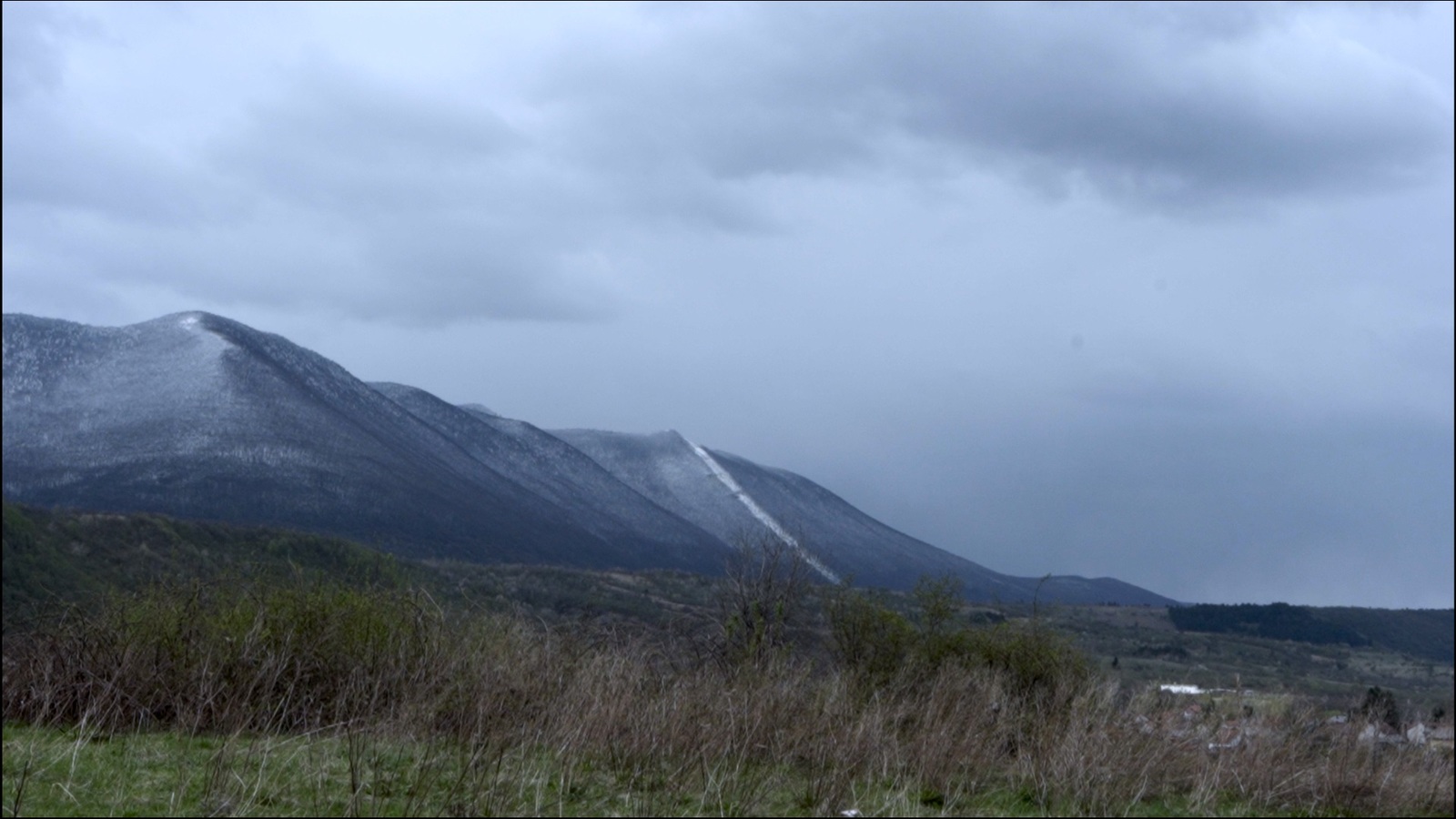 a snow covered mountain range in the distance