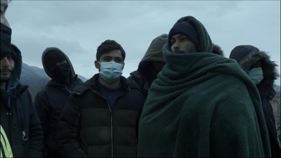 a group of people standing around each other wearing masks