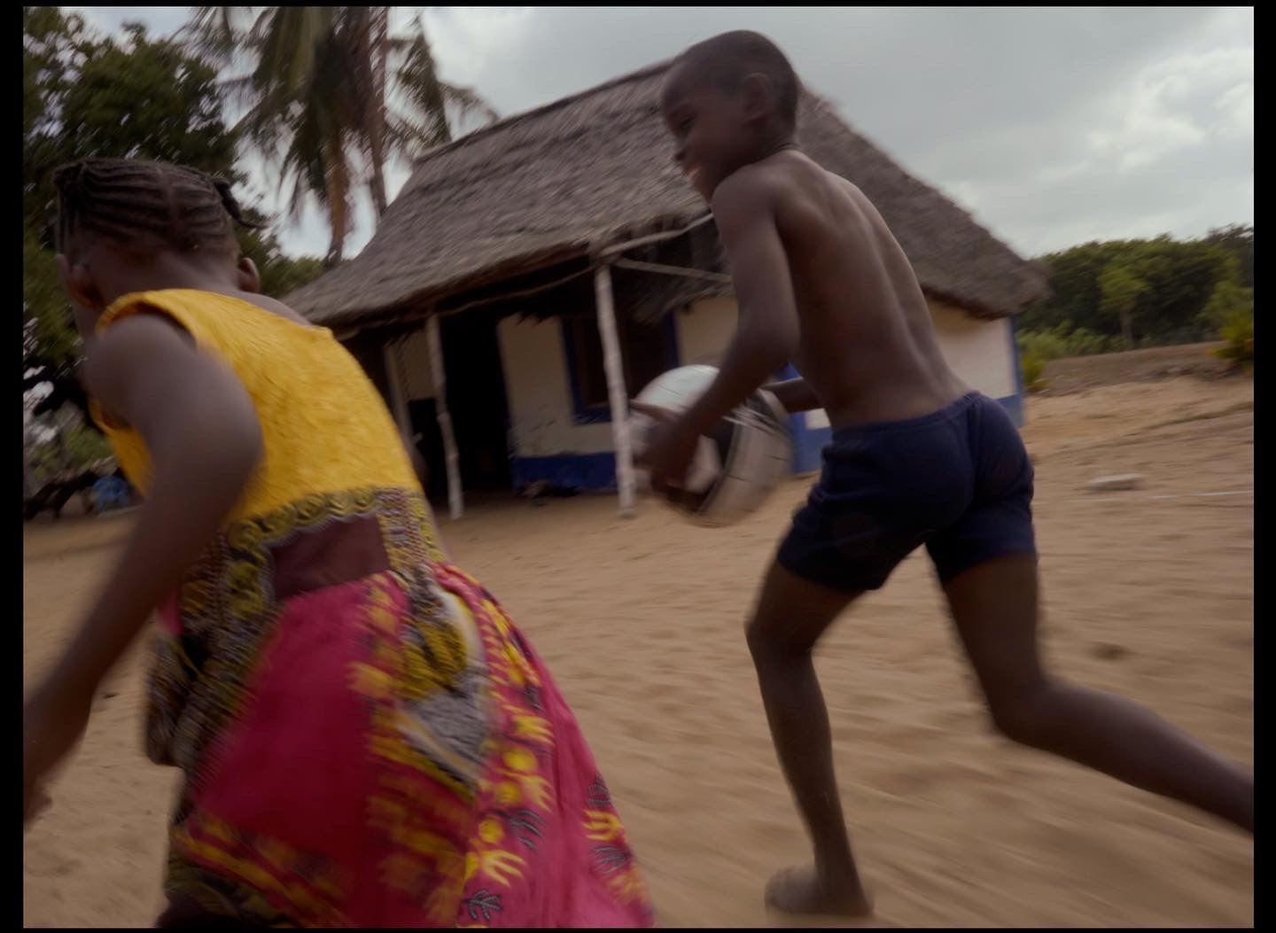 a couple of kids playing a game of frisbee