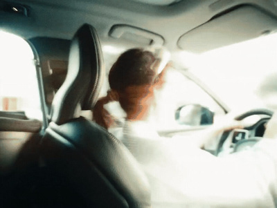 a woman sitting in the back seat of a car