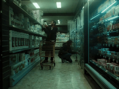 a man pushing a shopping cart through a grocery store