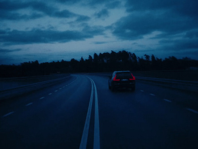 a car driving down a highway at night