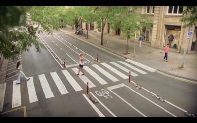 a couple of people walking across a street