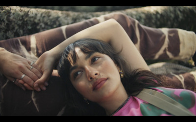 a woman laying on the ground with her hand on her head