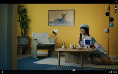 a woman sitting at a table with a book